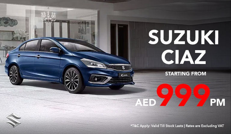 Blue Suzuki Ciaz parked indoors, showcasing sleek design. Text promotes leasing at "AED 999 PM" with terms. Modern, sophisticated atmosphere.